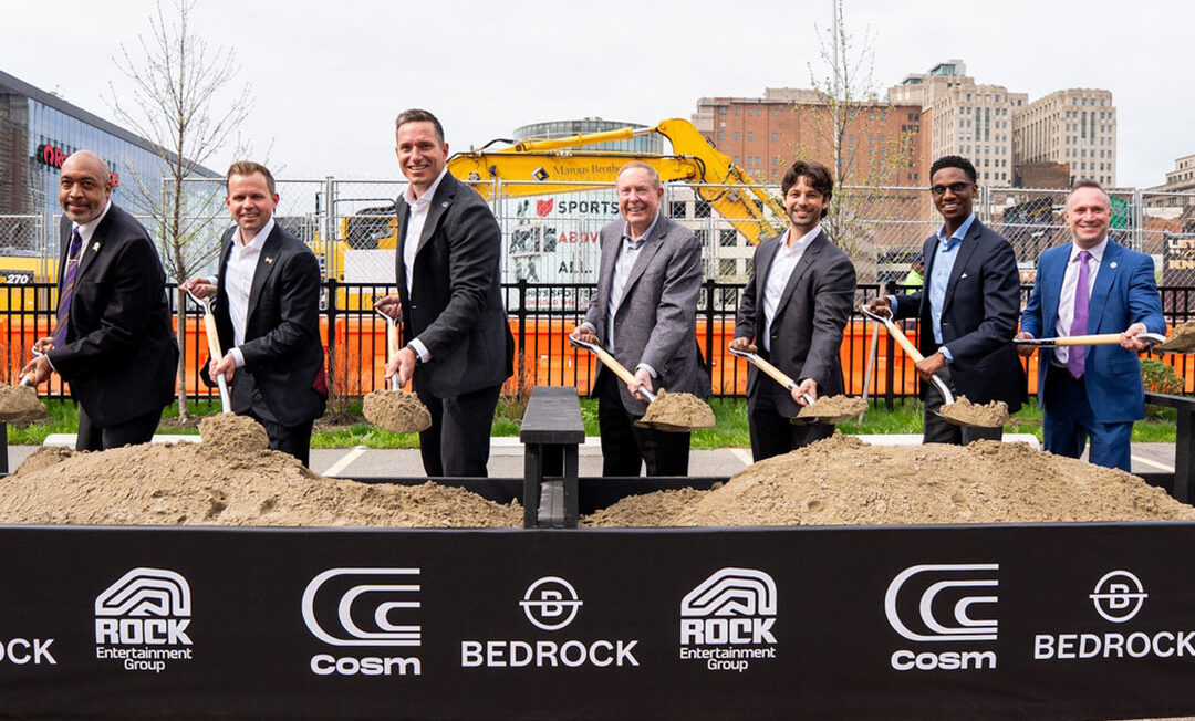 Mayor Justin M. Bibb stands with Cleveland City Council President Blaine A. Griffin, Cosm CEO Jeb Terry, Cosm Chairman Steve Winn, and Rock Entertainment Group CEO Nic Barlage in front of a bed of dirt, each holding a shovel, at a ceremonial groundbreaking event in Cleveland.