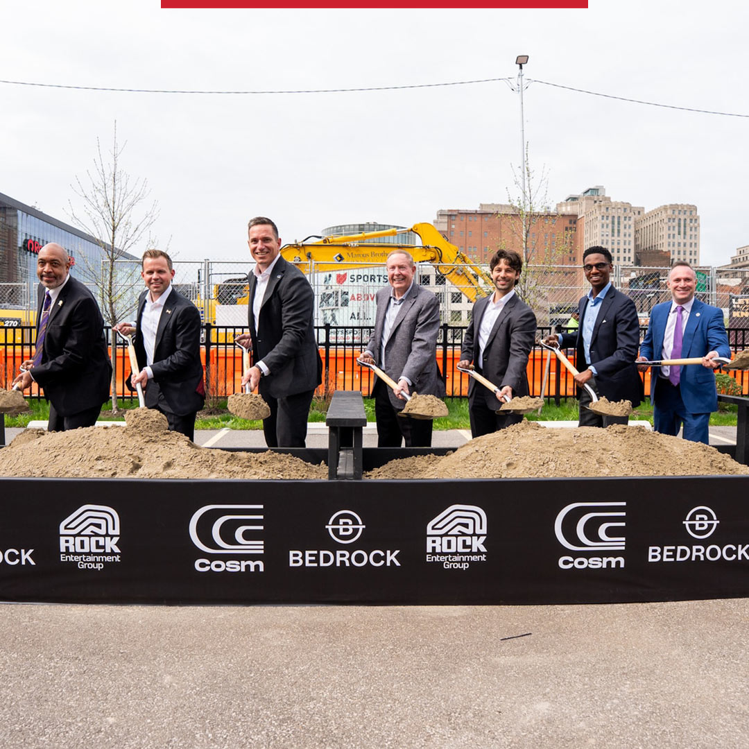 Mayor Justin M. Bibb stands with Cleveland City Council President Blaine A. Griffin, Cosm CEO Jeb Terry, Cosm Chairman Steve Winn, and Rock Entertainment Group CEO Nic Barlage in front of a bed of dirt, each holding a shovel, at a ceremonial groundbreaking event in Cleveland.